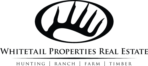 Whitetail Properties Real Estate logo with a deer hoof design.